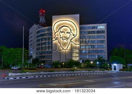 Havana, Cuba - Jan 13, 2017: Portrait of Camilo Cienfuegos on the Ministry of Informatics and Communications on Plaza de la Revolucion in Havana Cuba at night.