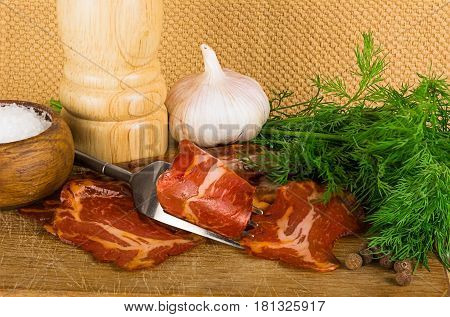 Country still life with bacon with pepper on wooden plate