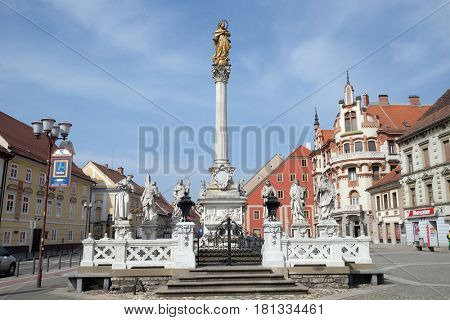MARIBOR, SLOVENIA - APRIL 03: Plague column at Main Square of the city of Maribor in Slovenia, Europe. Historical religious sculpture, April 03, 2016.