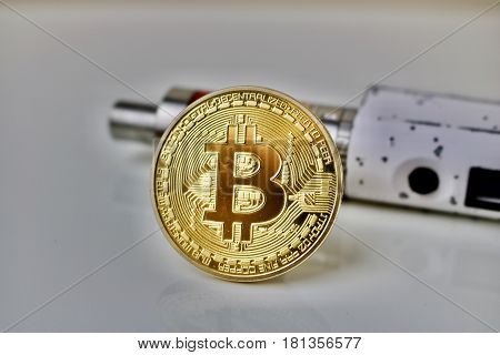 Bitcoin physical gold coin and old vaporizer