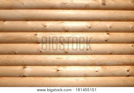 Background of horizontal hewed stooth wooden logs close up