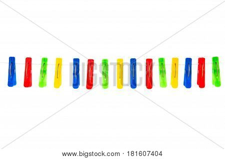 Some Colored Clothespins On A White Background