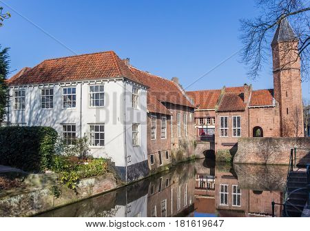 AMERSFOORT, NETHERLANDS - APRIL 09, 2017: City gate and houses at a canal in Amersfoort, Holland