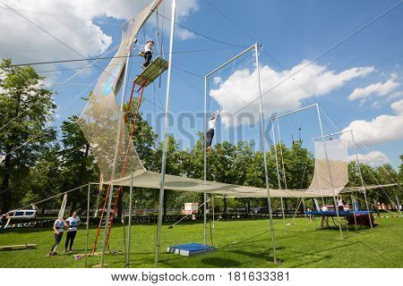 MOSCOW - MAY 26, 2016: Acrobats show on Trapeze. In Moscow, opened first in Russia trapeze for Air flight school and aerial gymnastics Trapeze Yota - school and show