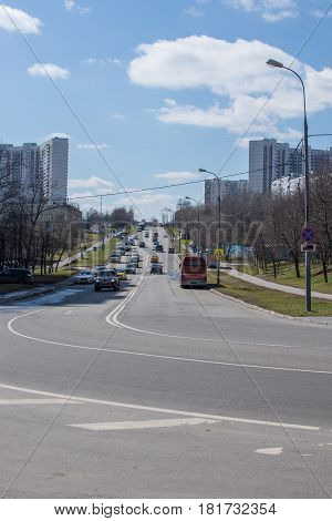Moscow Russia - 15 April 2017: Moscow road with sky. Cars drives down the road in Moscow