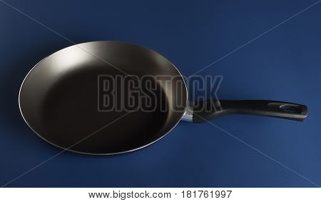Nonstick fry pan on blue background perfect for your delicious recipes