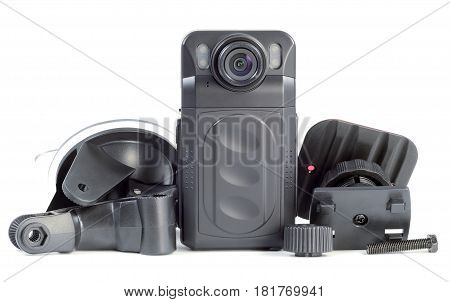 black plastic car DVR with designer fixtures for attaching to the car are on the table isolated on white background