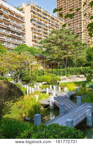 Monaco, Monte Carlo - September 17, 2016:  Jardin Japonais, Japanese Garden view with residential buildings at the background.