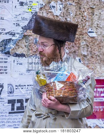 JERUSALEM - MARCH 13 : Ultra Orthodox man holding Mishloach Manot during Purim in Mea Shearim Jerusalem on March 13 2017 Mishloach Manot is traditional food gifts given during Purim