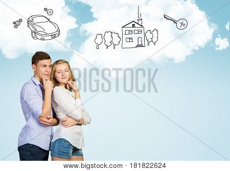Young happy family couple dreaming of future wealthy life