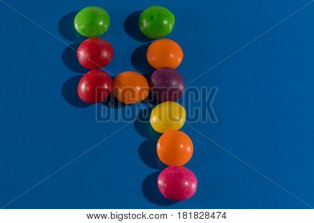 Image of colorful and tasty candies skittles figue four postcard