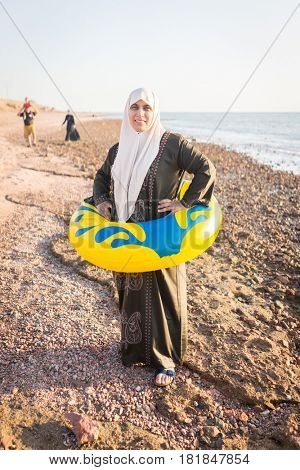 Muslim Arabic woman with burkini ready to swim in sea