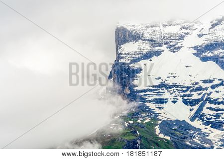 The Swiss Alps at Murren, Switzerland. Jungfrau Region. Tops of the mountains in fog and clouds.
