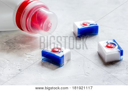 laundry set with pastel towels and detergent plastic bottel on stone table background