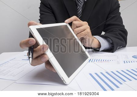 Business man hand pointing at business document during discussion at meeting.vintage tone