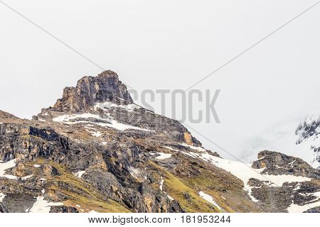 The Swiss Alps at Murren, Switzerland. Jungfrau Region. Tops of the mountains in fog and clouds.