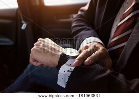Business man watching watch clock on hand