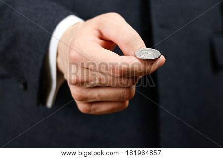 Businessman Tossing A Coin. Heads Or Tails. Close Up