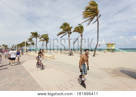 Hollywood Fl USA - March 13 2017: Inline skater and biker at the Hollywood beach broadwalk. Florida United States