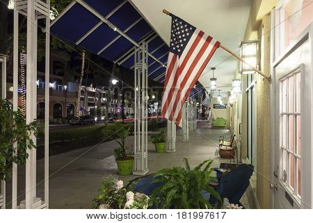 Naples Fl USA - March 21 2017: National flag of the united states at the display window of a shop in Naples downtown district. Florida United States