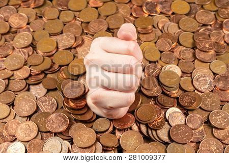 The Hand Which Is Sticking Out Of Heap Of Coins