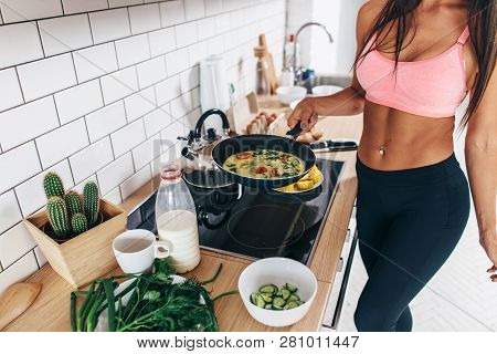 Fit Woman Standing At Kitchen Preparing Healthy Breakfast