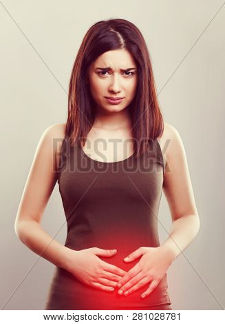 Young woman suffering from menstrual cramps pain or stomach health problems