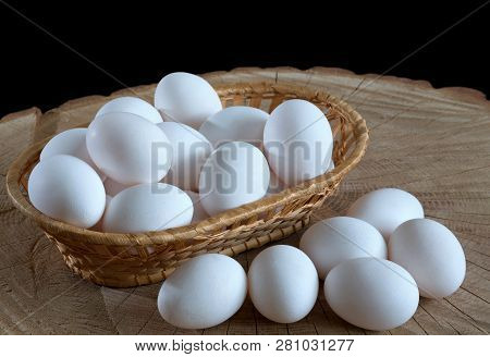 Chicken Eggs In A Basket On A Wooden Background