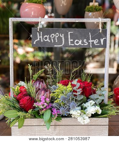 Easter Decor. Festive Flower Arrangement Of Protea, Red Roses, Limonium Sinuatum, Eryngium, Eucalypt