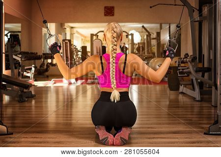 A Young Woman In The Gym Rocking The Back