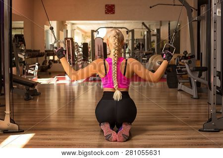 A Young Woman In The Gym Rocking The Back