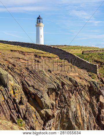 Rock Wall Leading To The Mull Of Galloway Lighthouse In Dumfries And Galloway, Scotland, United King