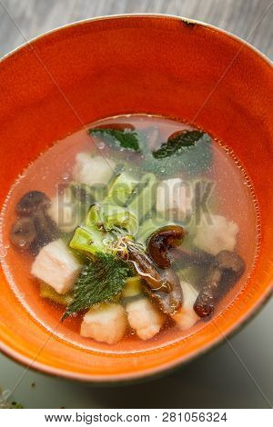 Closeup Noodle Soup With Mushrooms, Meat, And Nettle Leaves