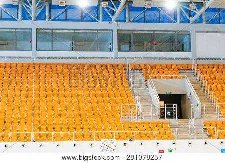 Poznan, Poland - January 26, 2019: Swimming Pool Tribune With Orange Seats And No People In The Term