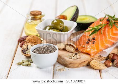 Selection Of Healthy Unsaturated Fats, Omega 3 - Fish, Avocado, Olives, Nuts And Seeds