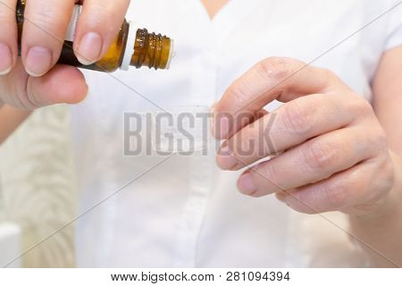 A Young Woman Doctor Distributes Portions Of Drugs In The Hospital, Determining Each Put Milliliters