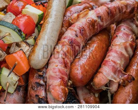sausages and vegetables on a grill