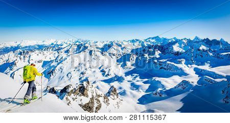 Skitouring with amazing view of swiss famous mountains in beautiful winter powder snow of Alps. 