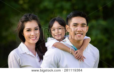 Asian Smile Family In Park, This Immage Can Use For Asia, Asian, Thai, Father, Mother, Kid, Daughter