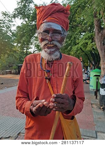 Tiruvanamalai, India - January 5, 2019: Begging Indian sadhu in the streets from Tiruvanamalai in India