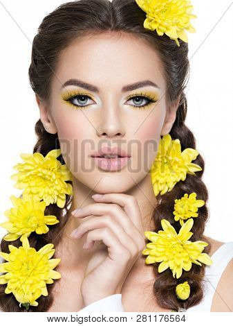Closeup face of an young beautiful woman with bright yellow make-up. Fashion portrait. Attractive girl with stylish hairstyle, pigtails -   isolated on white. Professional  makeup. 