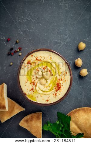 Chickpea Hummus In A Bowl, Cheackpeas, Pepper, Parsley And Pita Bread On Grey Background. Top View, 