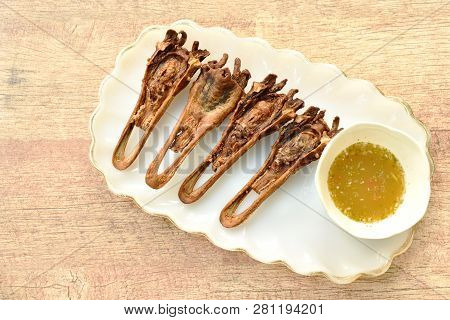 Deep Fried Duck Beak Dipping Spicy Sauce On Plate