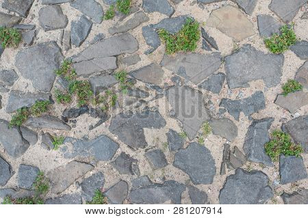 Road With Cobblestone And Overgrown By Grass. Top View
