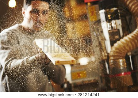 Man Blows Sawdust Off The Wood After Sanding Cnc Router Machine. Device With Numerical Control.