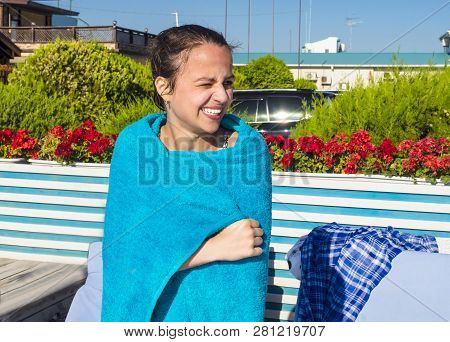 A Young Girl Is Warming Up Just After A Swim In A Pool.