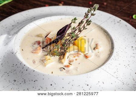 American Cuisine Concept. American Soup Clam Chowder With Chicken Broth And Milk, With Bacon And Mus