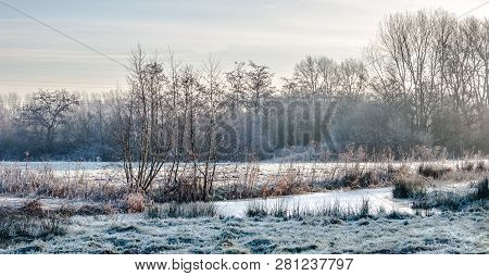 Frozen Swamp In A Winter Landscape With Open Water And Wetlands, And Rime Covered Vegetation. Diemer