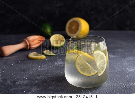 Summer Citrus Lemonade Alcohol Cocktail Gin Tonic With Squeezed Lemon And Lemon Reamer Or Juicer Dar