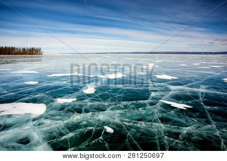 Frozen Lake Khubsugul. Beautiful Forest Near The Ice Surface On A Frosty Day. Natural Background